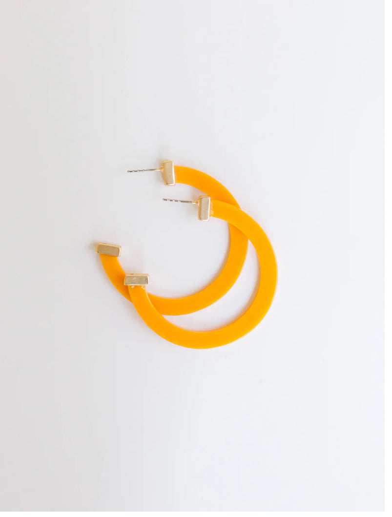 Bright orange hoop earrings with gold-tone accents and post-back closures