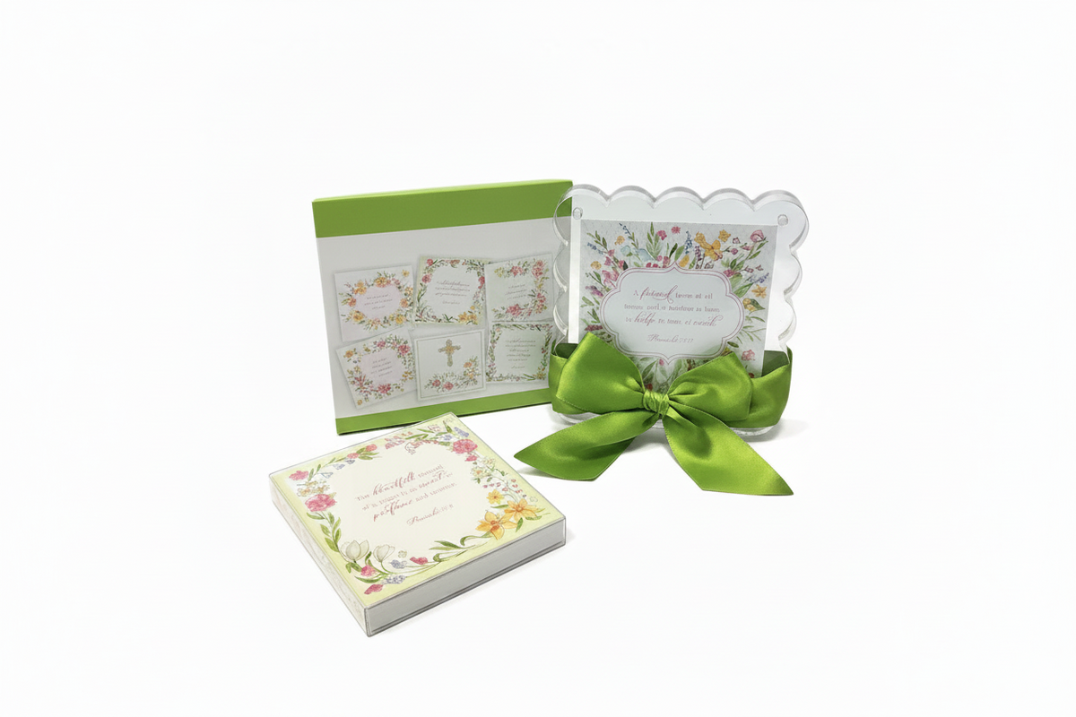 A set of floral-themed religious stationery, including a small square card stack with a cream floral border, a larger square card with a green cover, and a clear scalloped invitation card tied with a bright green satin bow, all on a white background.
