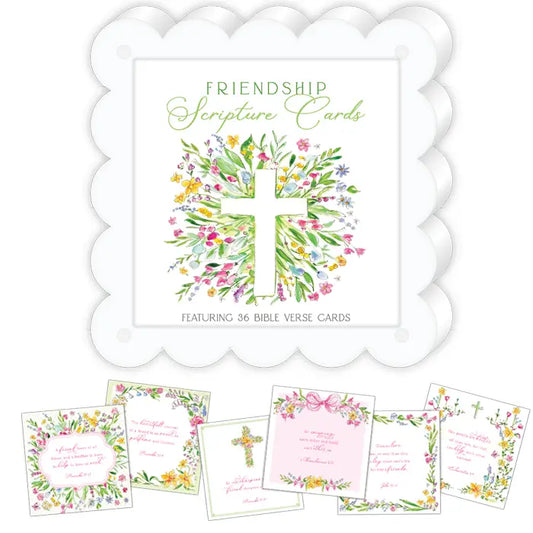 Friendship Scripture Cards set featuring a white scalloped card holder with a floral cross illustration, surrounded by several sample verse cards in pastel pink, green, yellow, and white floral designs.