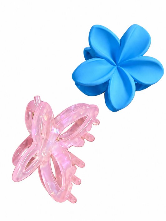 Two plastic hair claw clips on a plain white background: one translucent pink butterfly clip and one solid blue flower clip.