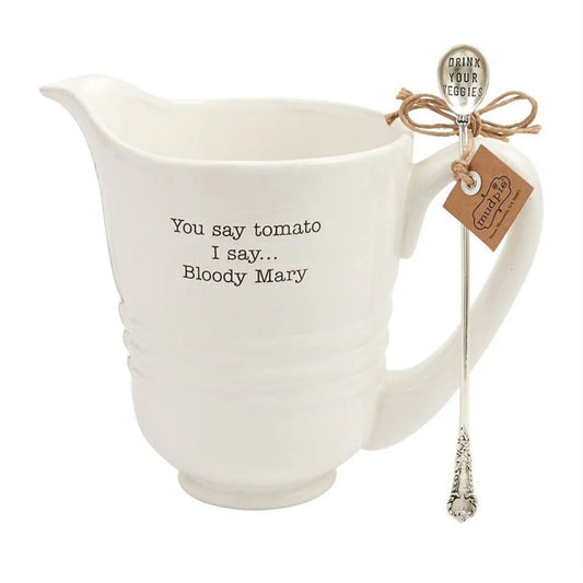 White ceramic pitcher with text and a spoon on a white background