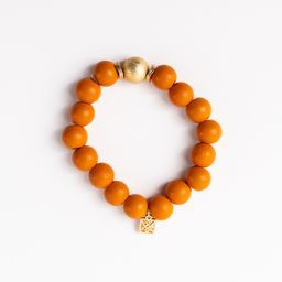 beaded orange bracelet with one gold bead