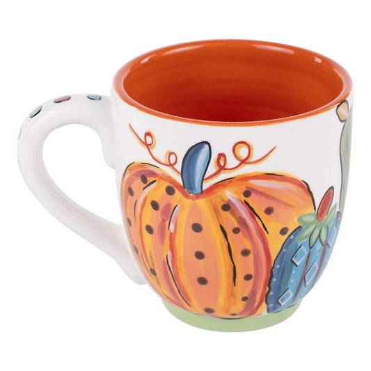 Ceramic mug with a colorful pumpkin design on a white background