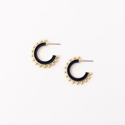 small hoop earrings with navy enamel color and gold beads lining the exterior