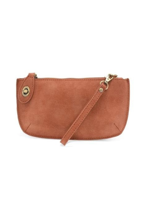 A small brown faux-leather clutch bag with a curved bottom, a top zipper closure, a matching wristlet strap, and gold-tone hardware, shown against a plain white background.