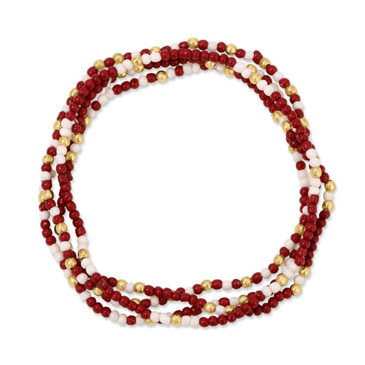 Multistrand beaded necklace with red, white, and gold beads on a white background