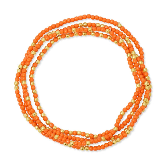 Orange beaded necklace with gold accents on a white background