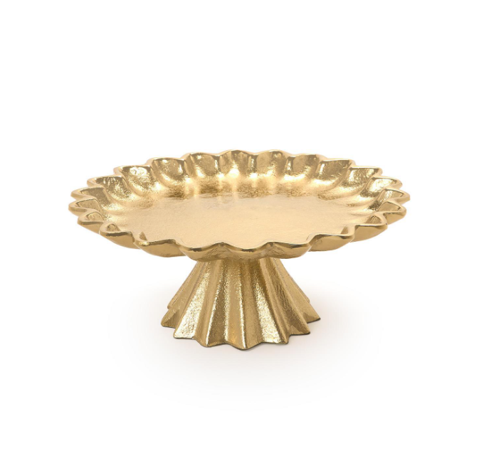 A gold pedestal tray with a scalloped rim and fluted base, shown on a clean white background.
