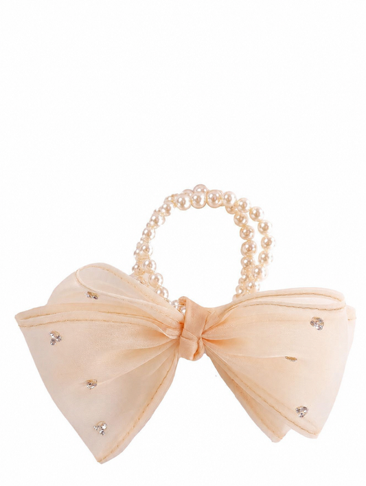A peach-colored bow with small rhinestones and featuring pearl-beaded hair ties