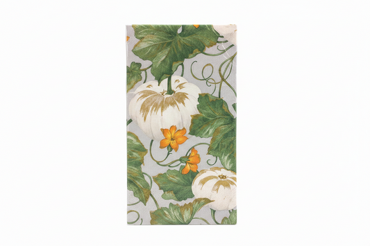 A rectangular fabric item, likely a napkin or small towel, featuring a vintage-style botanical print of white pumpkins, green vines, and orange flowers on a light gray background.