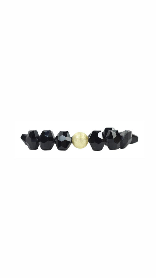 shiny black beaded bracelet with one gold bead