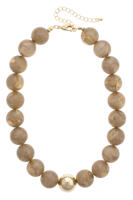 Necklace with beige marbled beads and gold accents on a white background