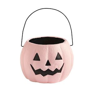 Pink pumpkin-shaped candy bucket with black handle on a white background