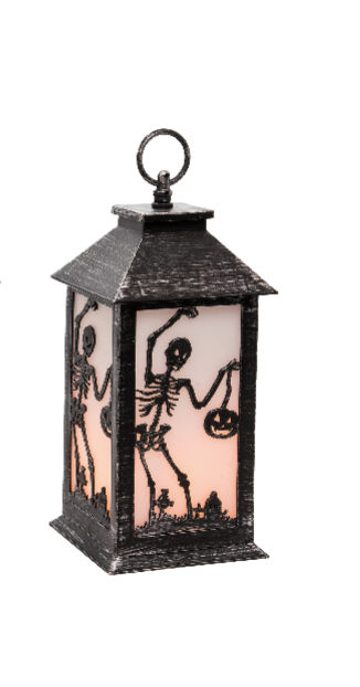 A Halloween lantern with a distressed black metal frame and skeleton cutouts, featuring a warm pinkish-orange glow from within, shown on a plain white background.