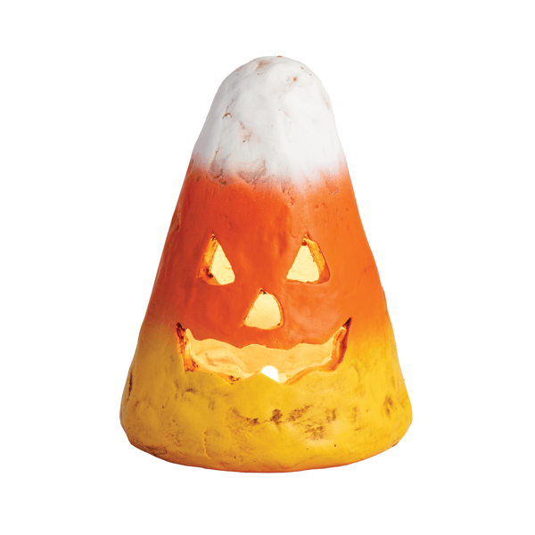 A small Halloween decorative object shaped like a candy corn, with a carved jack-o'-lantern face and a warm yellow glow from within, shown on a plain white background.
