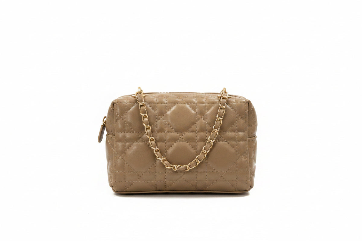 A quilted beige shoulder bag with a gold-tone chain strap, shown against a plain white background.