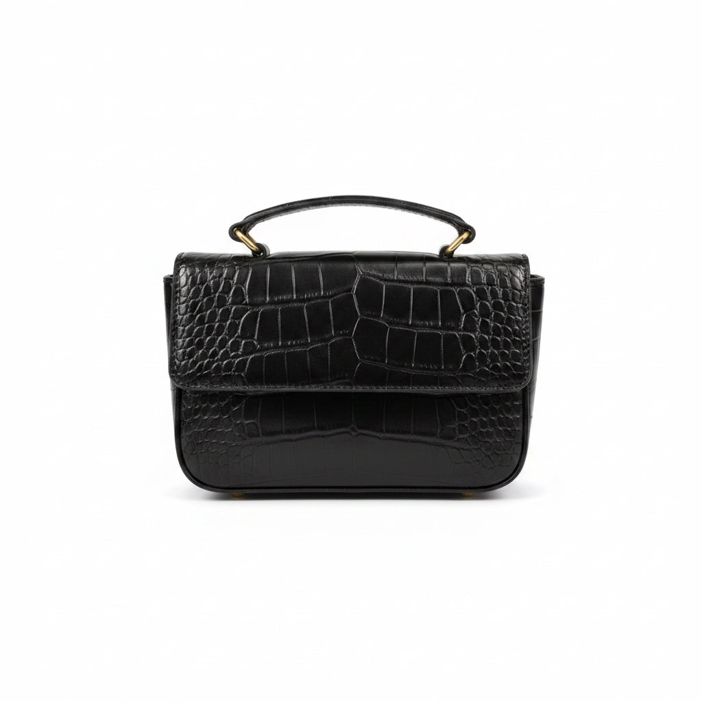 A black crocodile-embossed leather handbag with a top handle and gold-tone hardware, shown against a plain white background.
