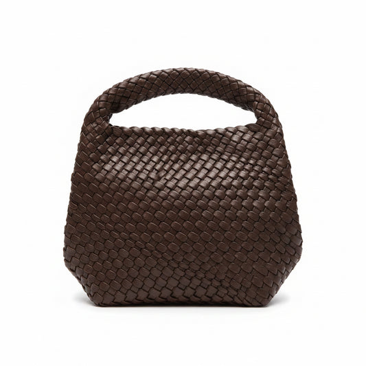 Brown woven handbag on a store counter with price tags attached
